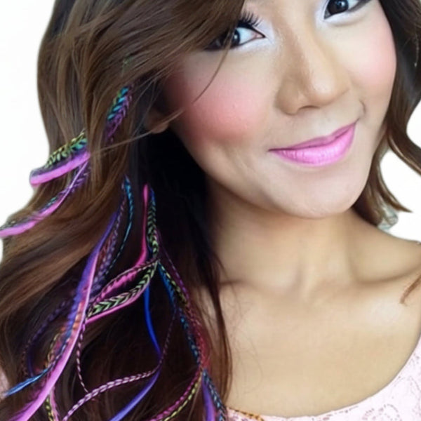 Woman with colorful feather hair extensions on a white background