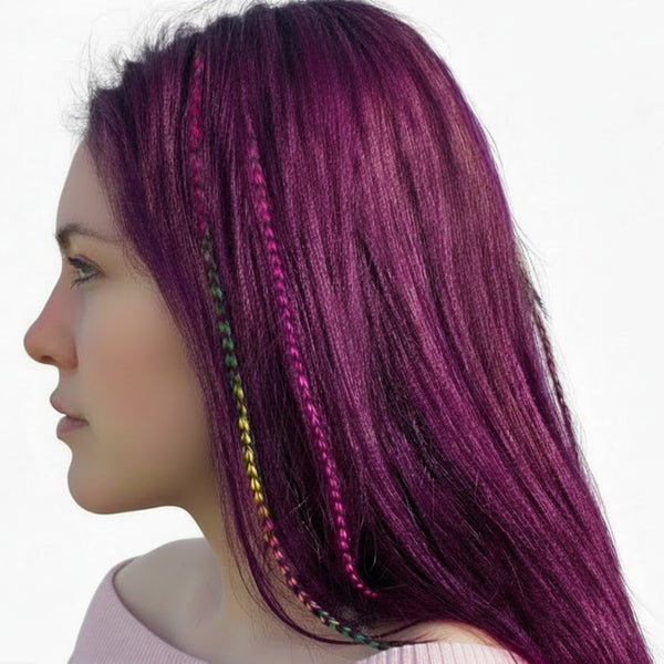 Close-up of a person with purple hair featuring colourful hair feathers on a white background