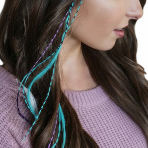 Close-up of a woman's hair with teal and purple braided extensions.