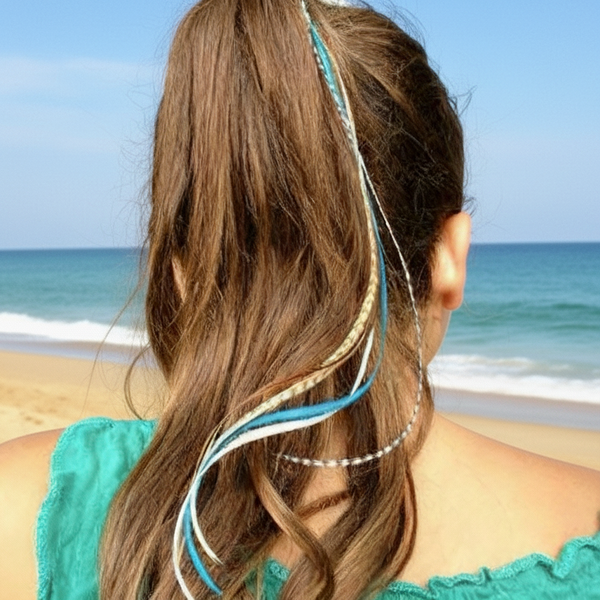 Person with feather hair extensions in a garden setting